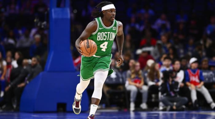 Boston Celtics guard Jrue Holiday brings up the ball.